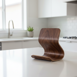 Wooden tablet stand on a white countertop with a blurred kitchen background